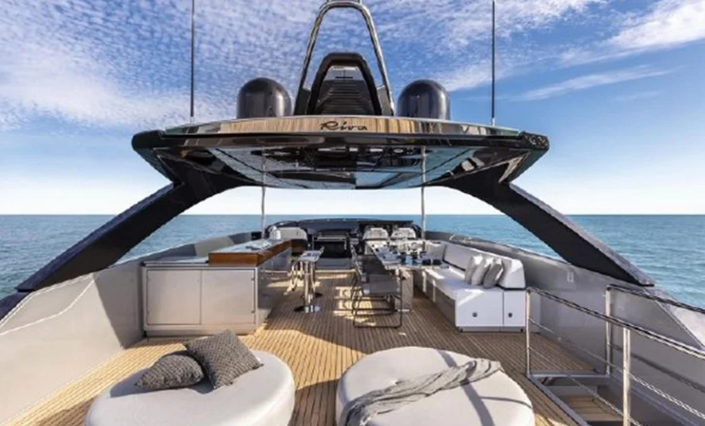  A lavish yacht interior featuring elegant furnishings, polished wood accents, and large windows showcasing the sea view.
