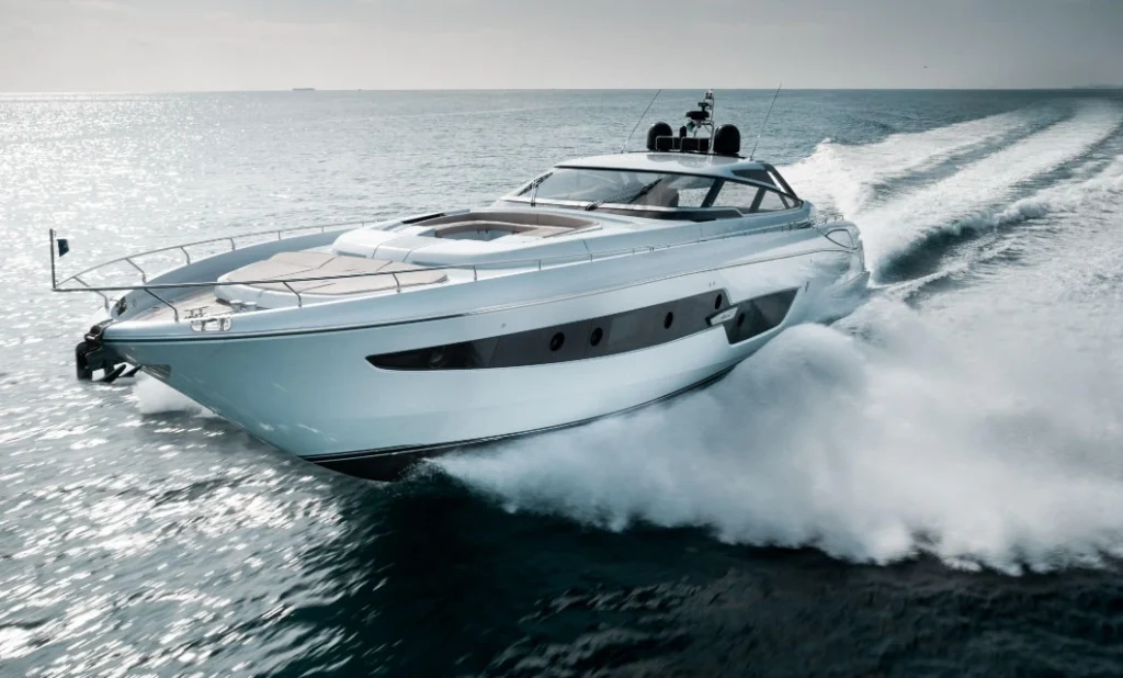 A luxury motorboat glides swiftly across the water, leaving a trail of waves in its wake.