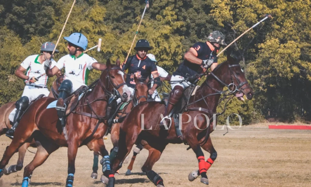 Four polo players on horseback in action, holding mallets, with a forested background and "LA POLO