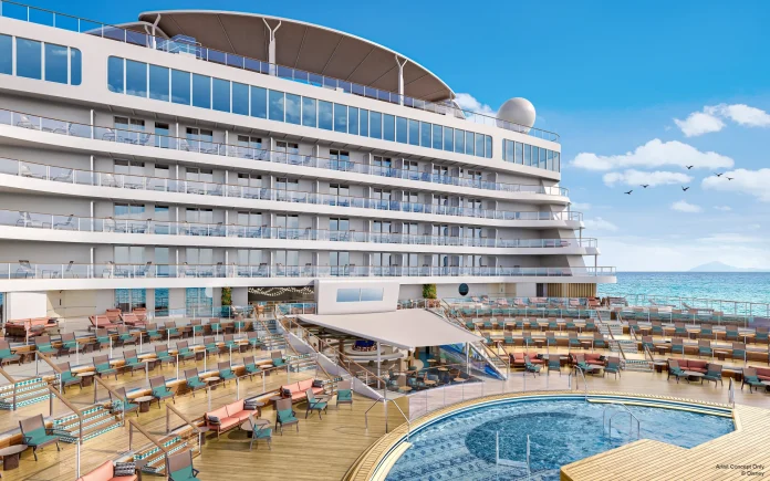 Luxury cruise ship deck with pool and sun loungers, overlooking a serene ocean view under a clear blue sky.