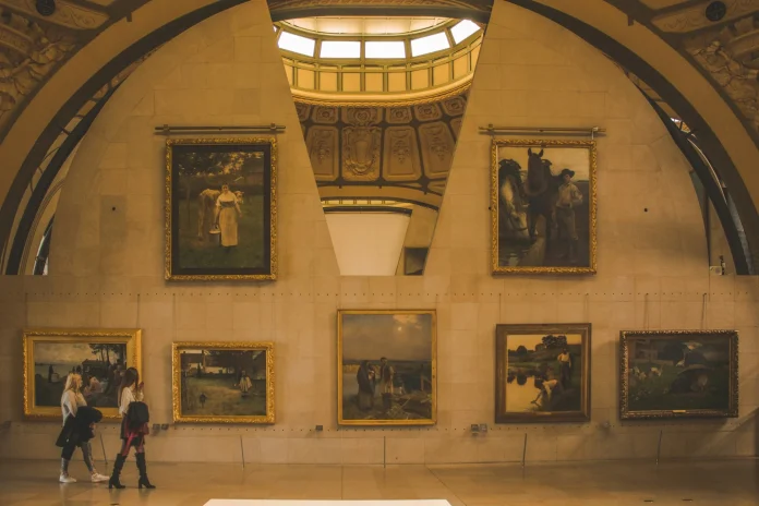A charming room featuring an array of vibrant paintings displayed on the walls, enhancing the space's artistic vibe.